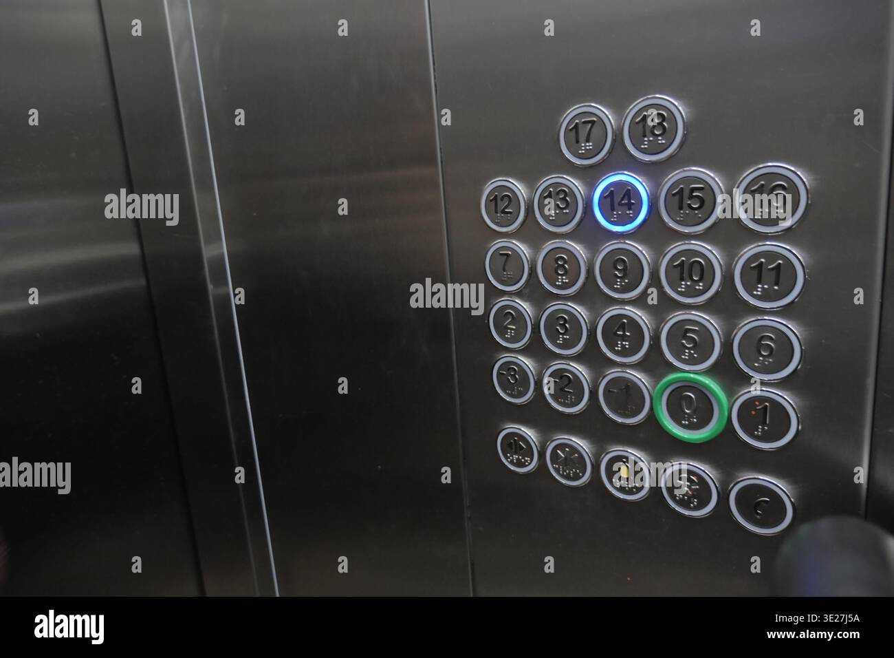 Button panel shows elevator options on a steel surface Stock Photo