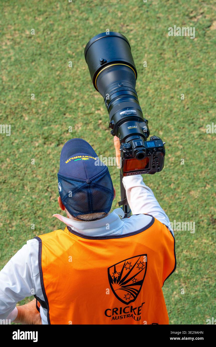 An accredited professional photographer with a Nikon mirrorless camera and telephoto lens at  the NSW v WA Sheffield Shield game in Sydney in March 26 Stock Photo
