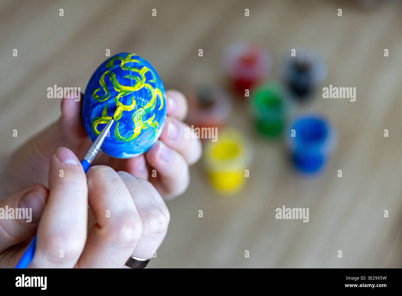 Woman is painting eggs preparing for Easter. Stock Photo