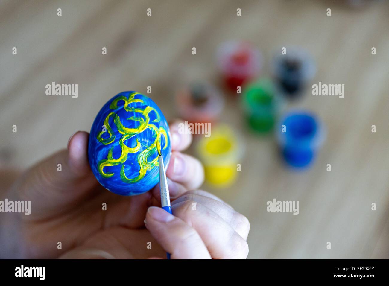 Woman is painting eggs preparing for Easter.  Stock Photo