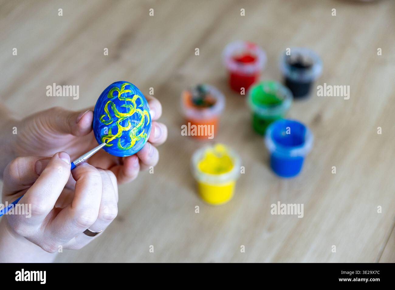 Woman is painting eggs preparing for Easter.  Stock Photo