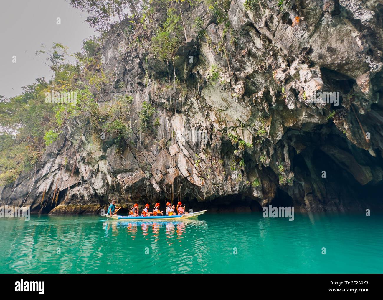 Tourists in a boat entering Puerto Princesa Underground River, Palawan, Philippines, exploring limestone cave formations. - Smartphone Captured Stock Image