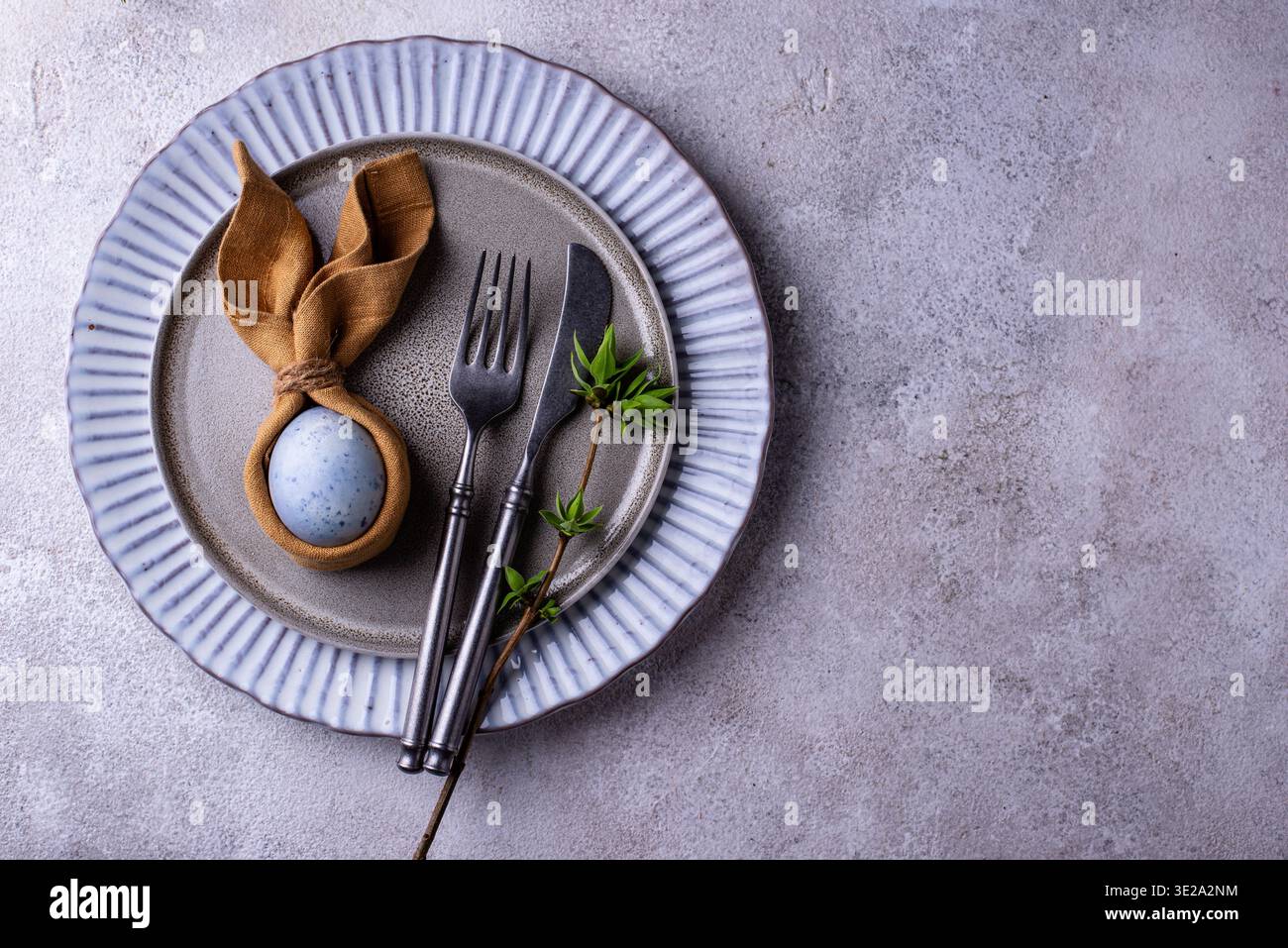 Elegant Easter table setting with painted egg Stock Photo