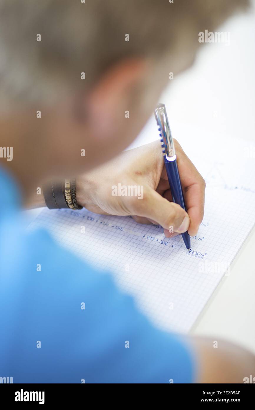 Students write mathematical calculations hi-res stock photography and ...