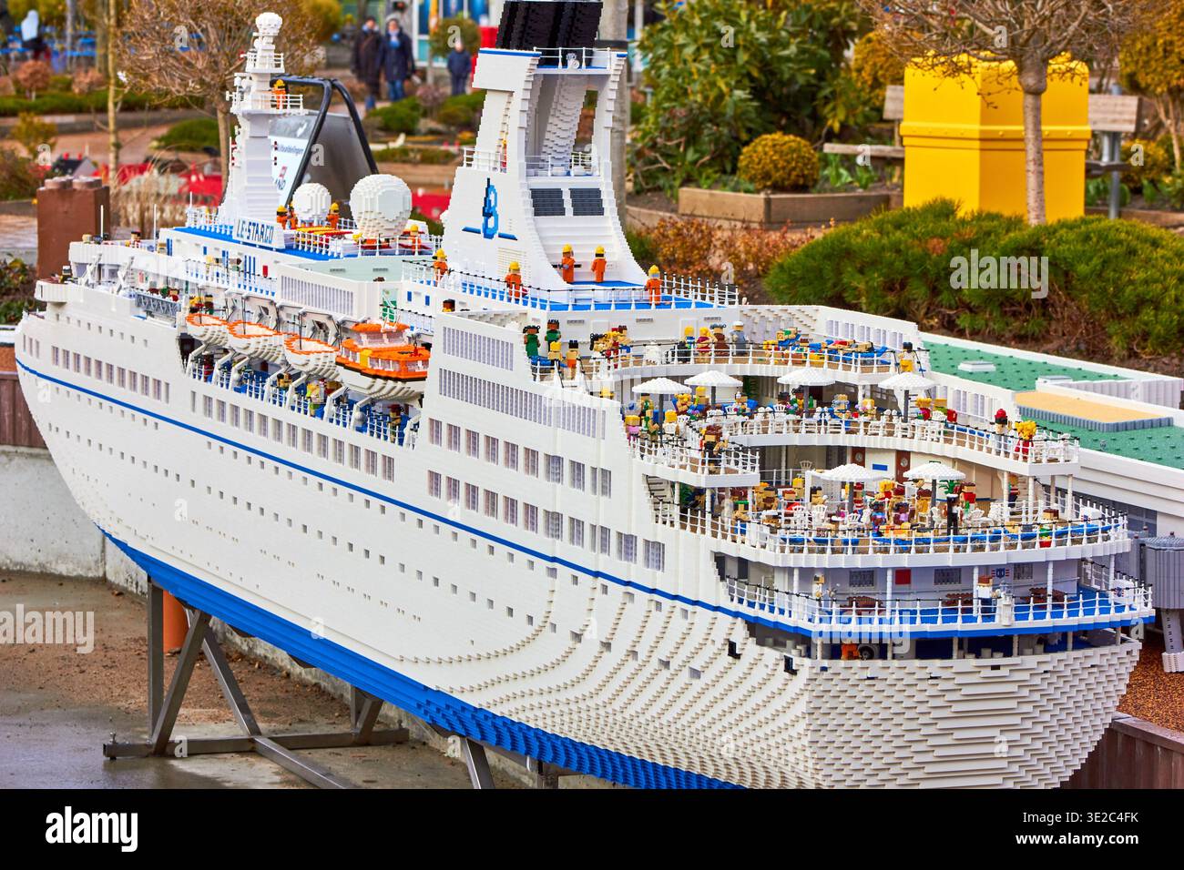 Denmark â€“ March 19, 2022: A detailed LEGO model of a large white cruise ship displayed outdoors, featuring multiple decks with railings, lifeboats, Stock Photo