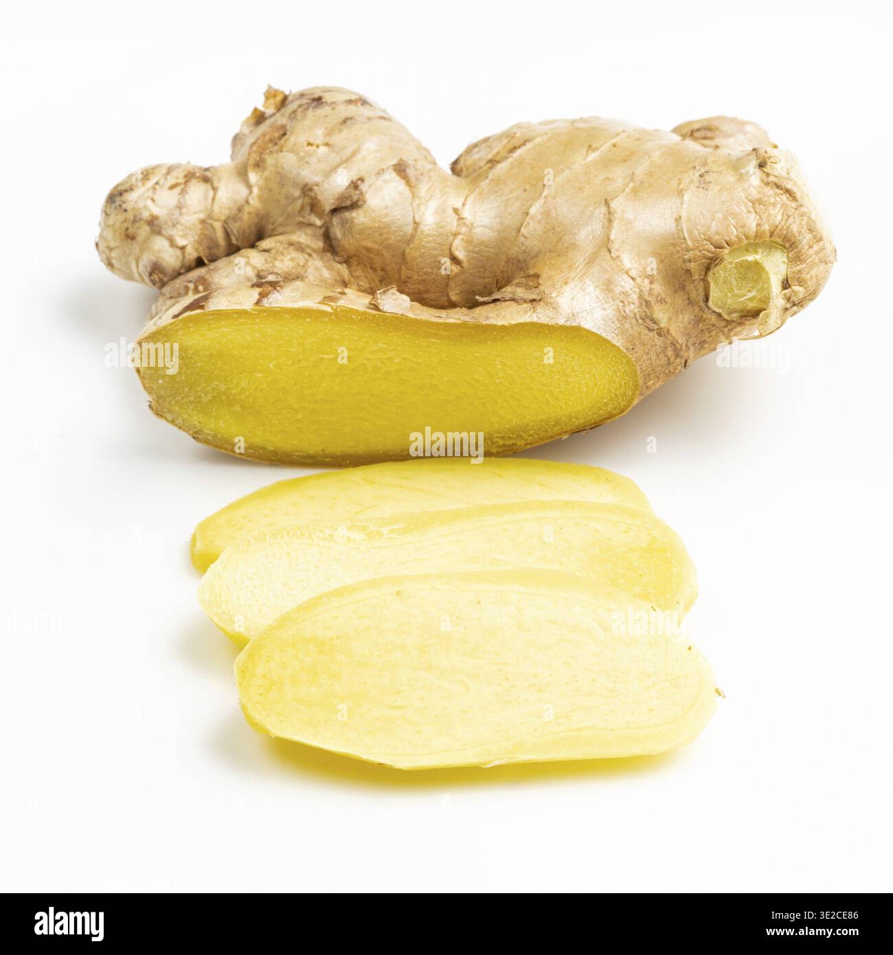 Sliced fresh ginger root on gray plate close up Stock Photo