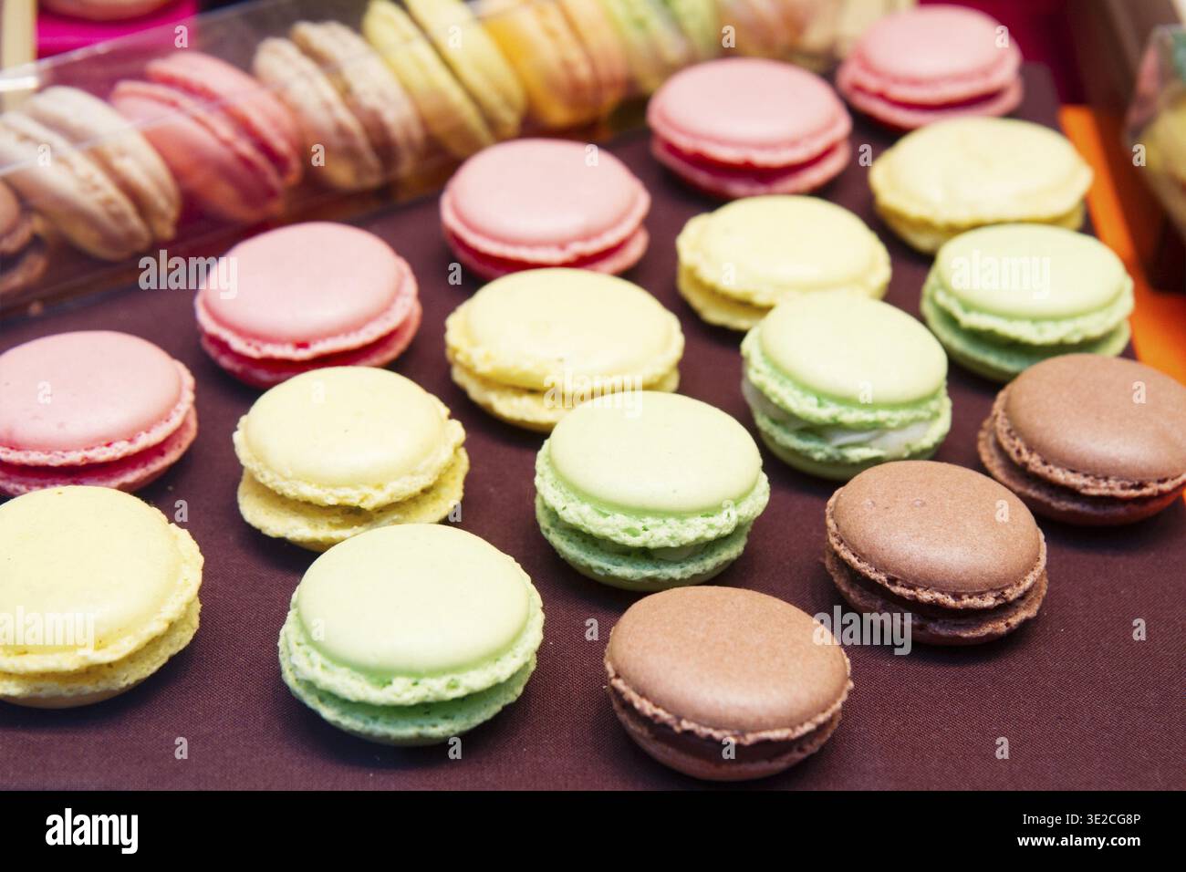 Rows of assorted french multicolored macaroons on table Stock Photo