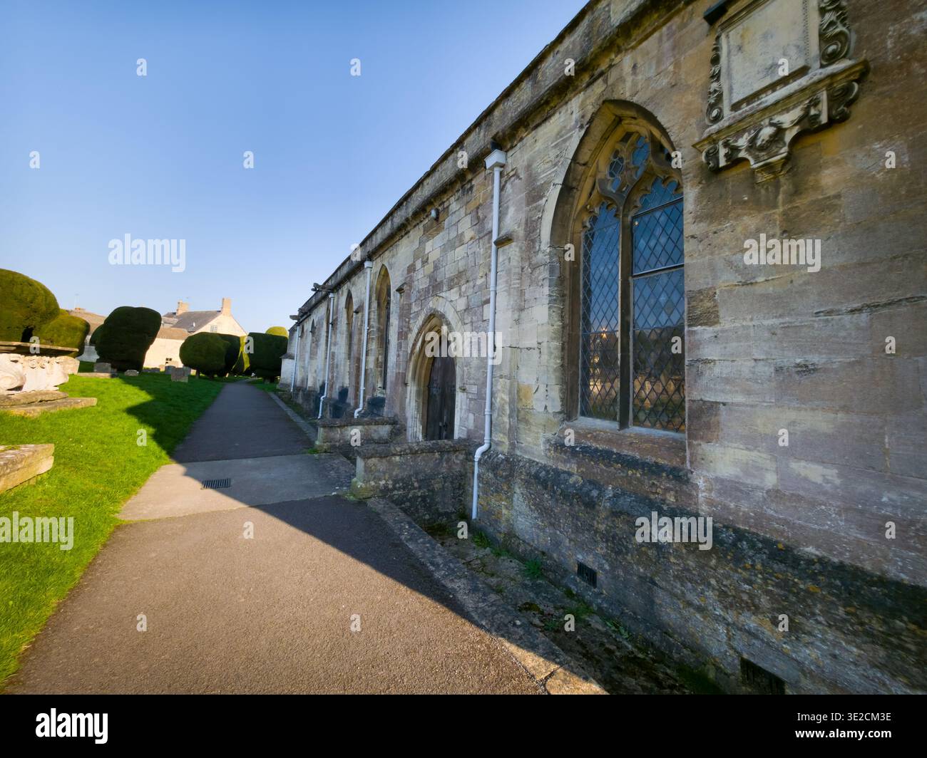 St Mary's Church Spire with Iconic Yew Trees in Churchyard, Painswick, Cotswolds, Gloucestershire, England - Smartphone Captured Stock Image
