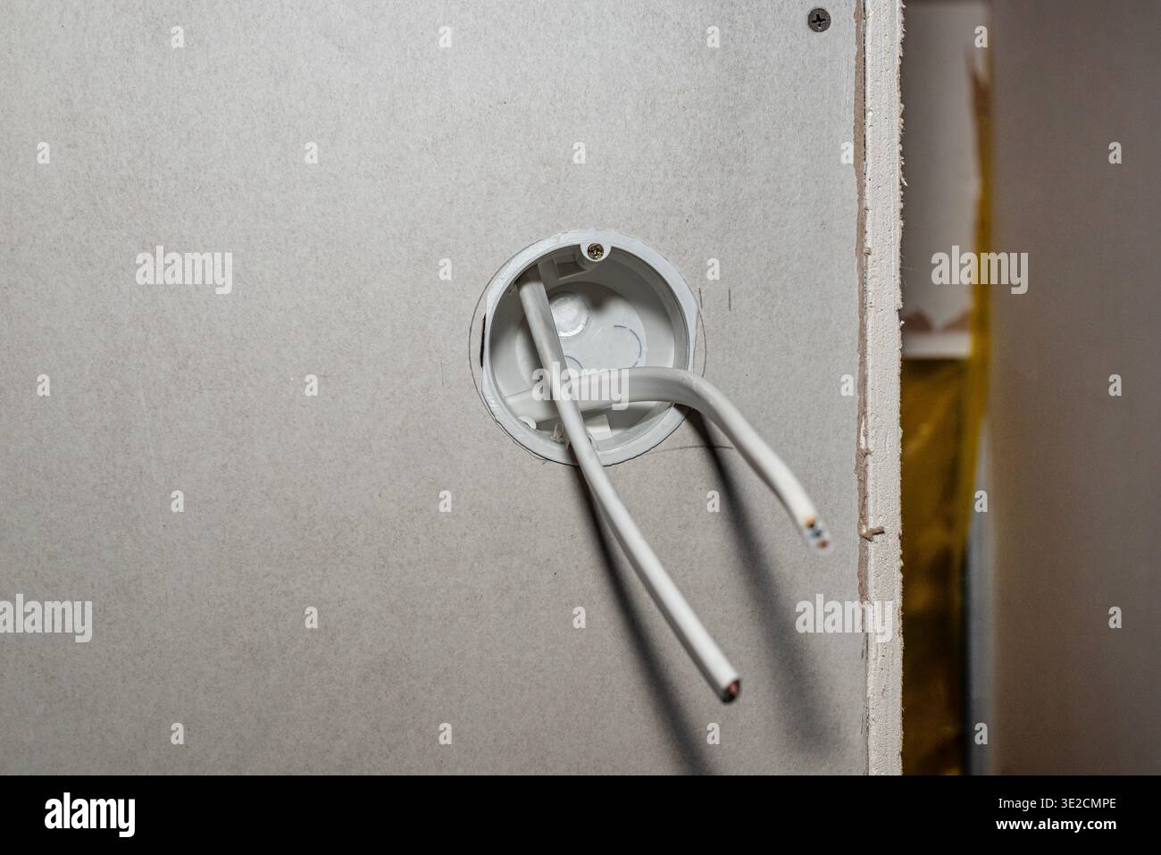 Electrical box with wiring inside new drywall in a construction project Stock Photo