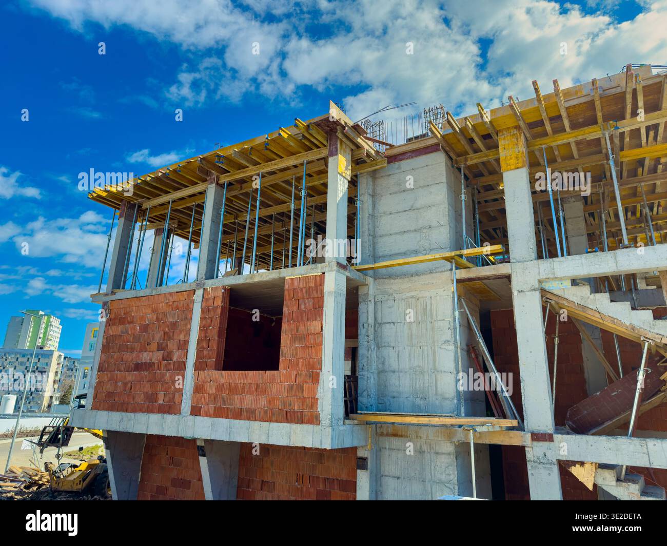 Workers continue building a new structure with concrete and bricks ...