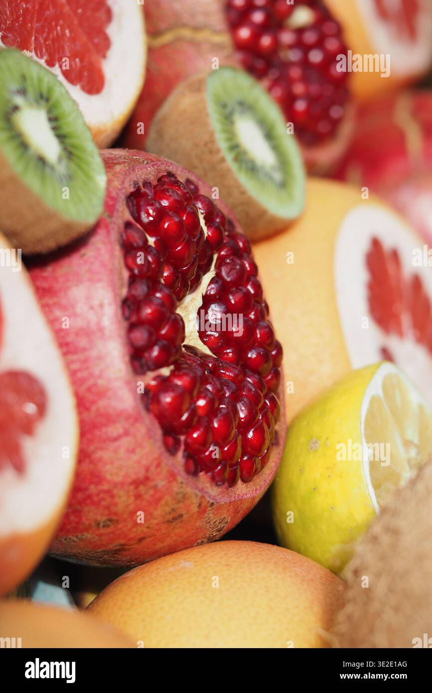 Fruits arranged for display with focus on pomegranate Stock Photo