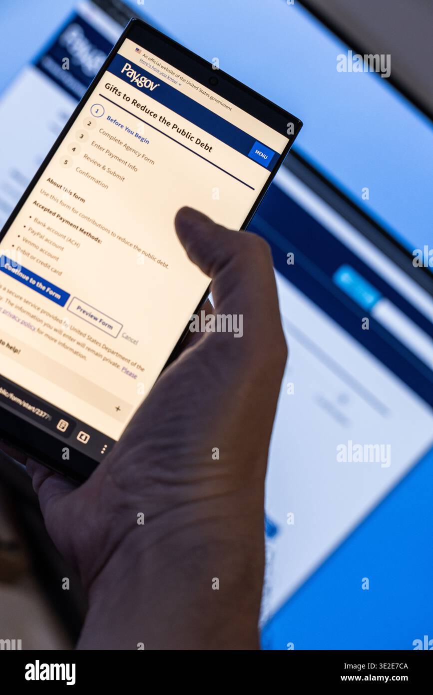 Smartphone with pay.gov Debt Reduction Form on the screen in Balykchy, Kyrgyzstan - February 16, 2026 Stock Photo