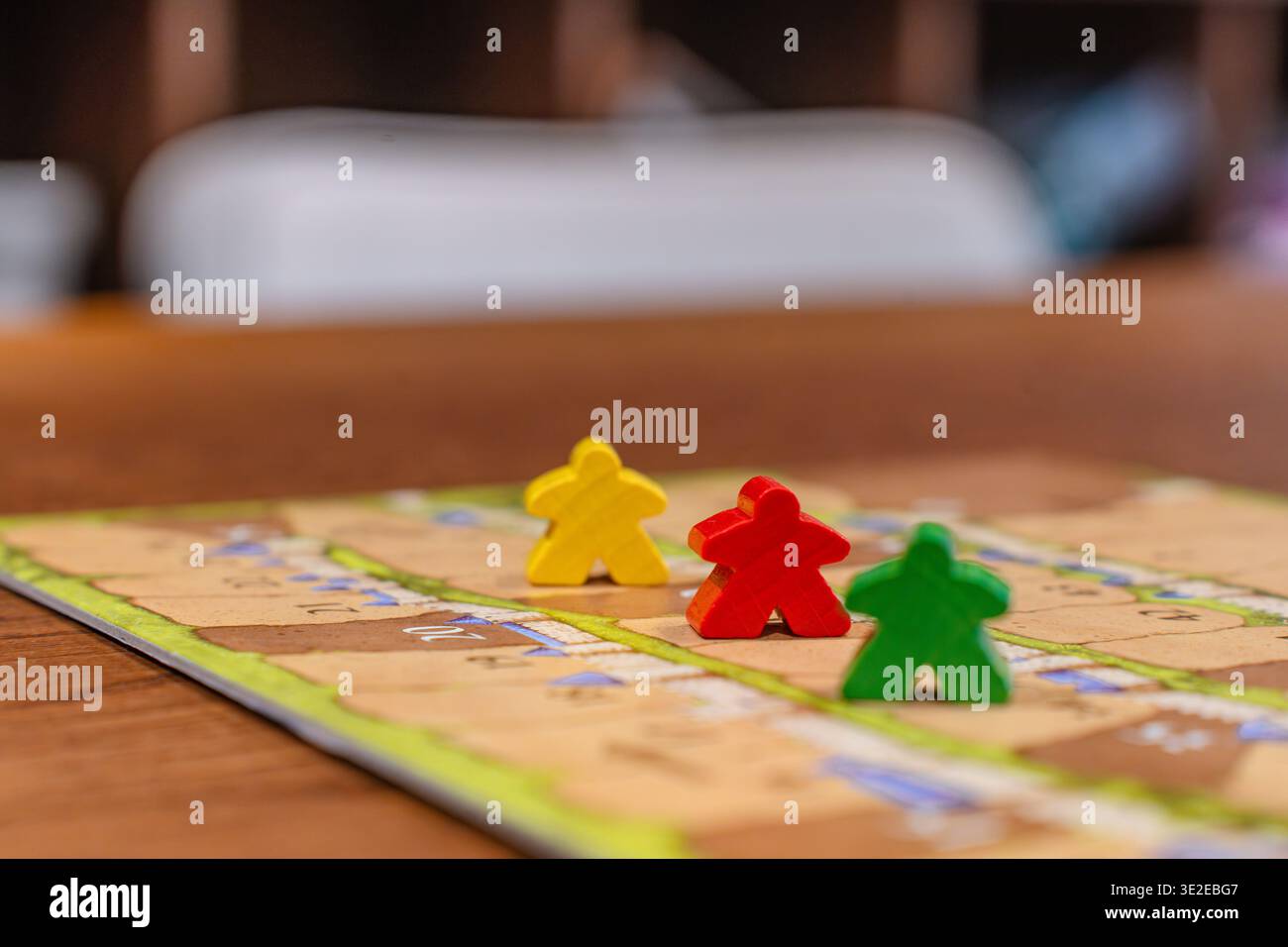 Colored game figures chips for board games. Collection of dice cubes on green table Stock Photo