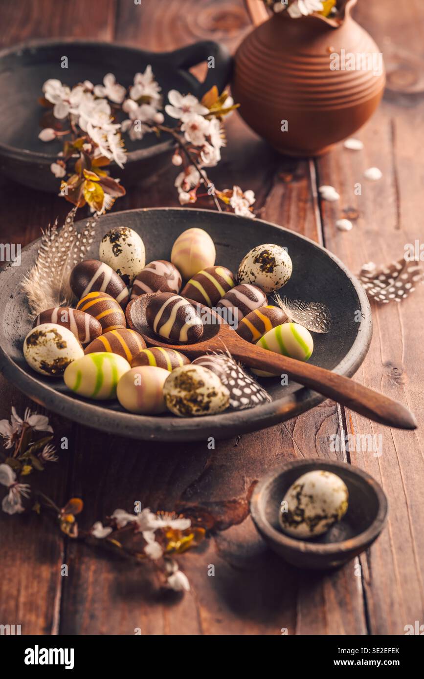 Easter place setting with sweet chocolate eggs, spring celebration Stock Photo