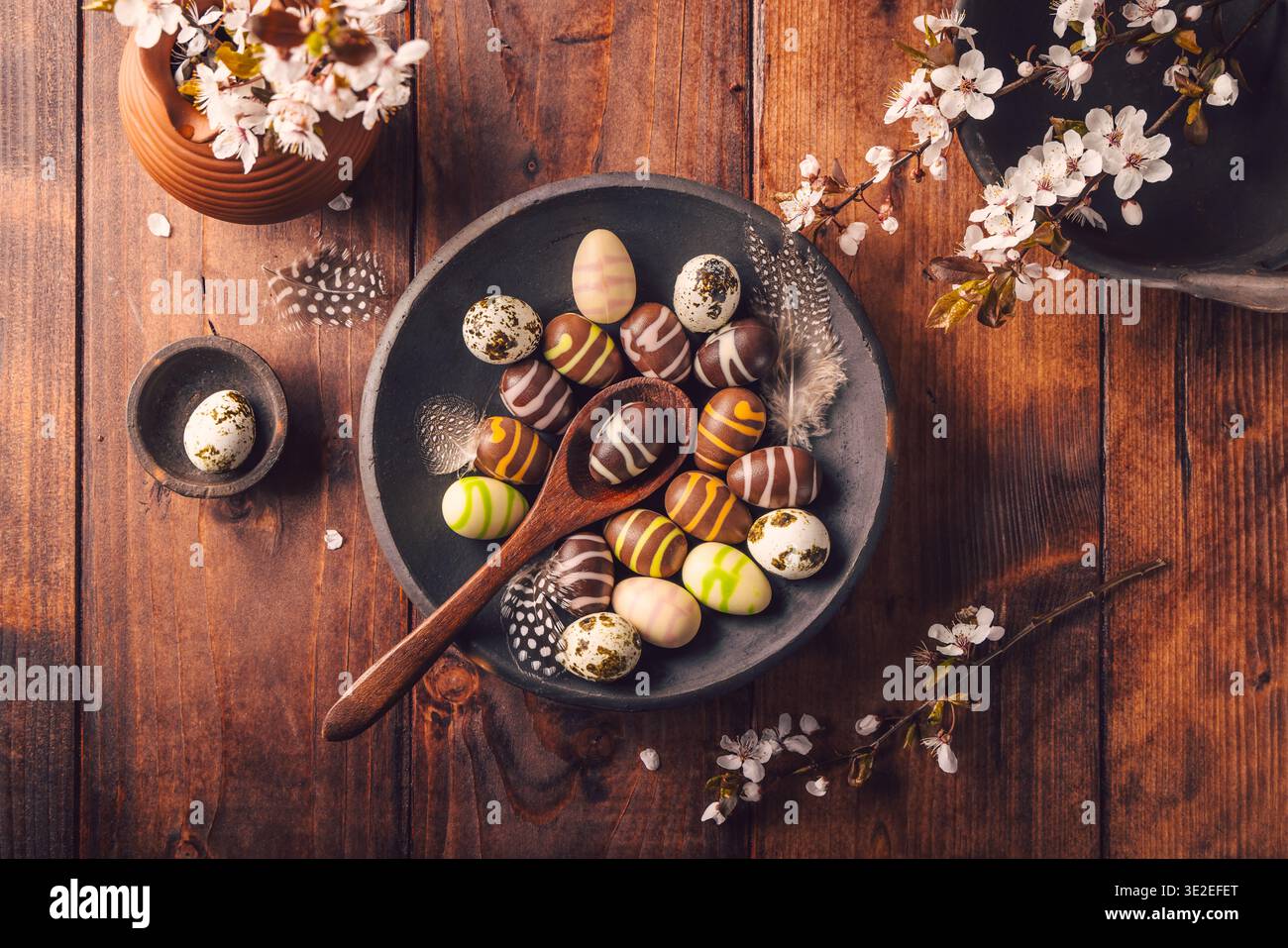 Easter place setting with sweet chocolate eggs, spring celebration Stock Photo