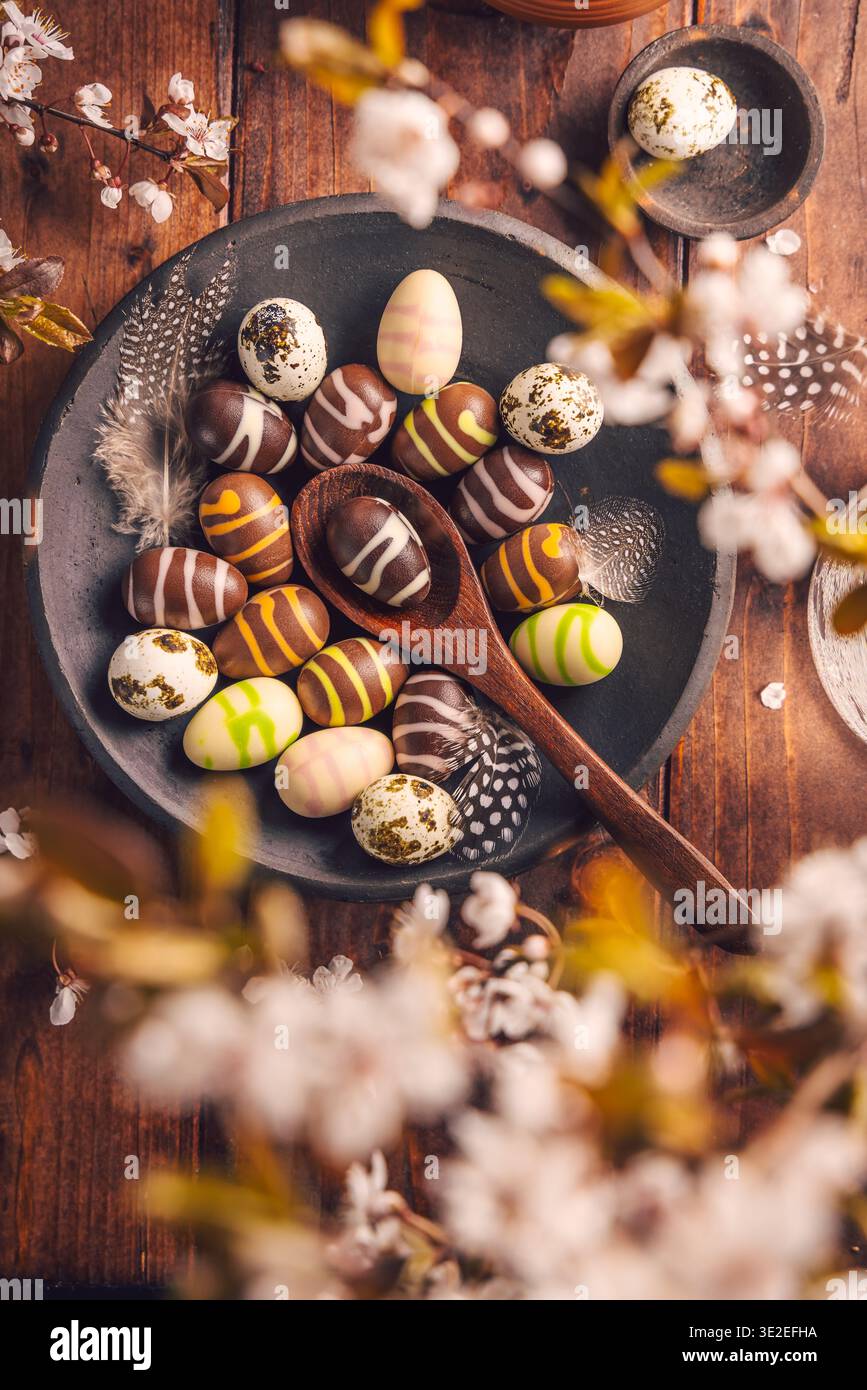 Easter place setting with sweet chocolate eggs, spring celebration Stock Photo