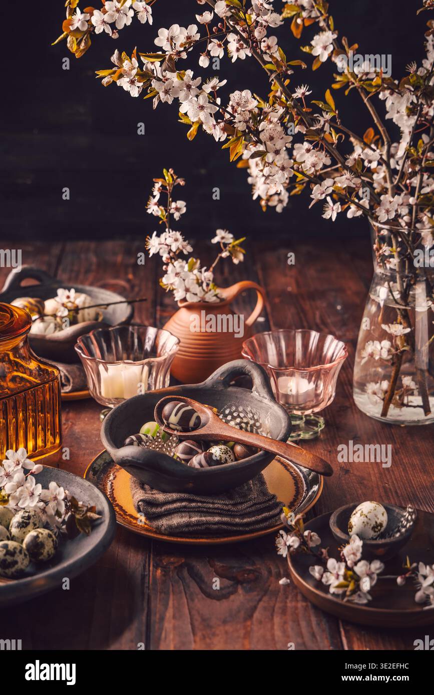 Easter place setting with sweet chocolate eggs, spring celebration Stock Photo
