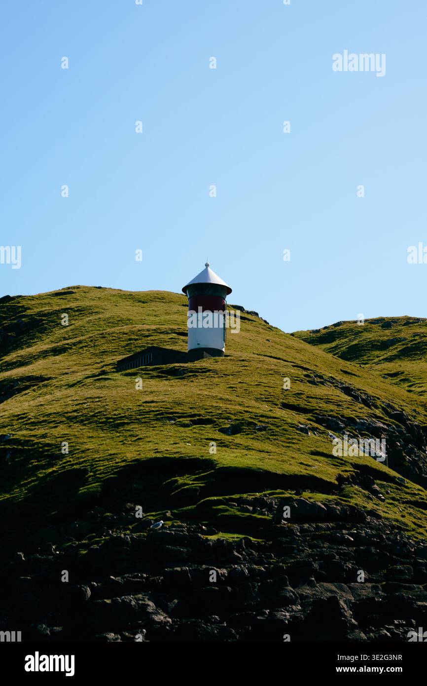 Lighthous on a green hil Stock Photo