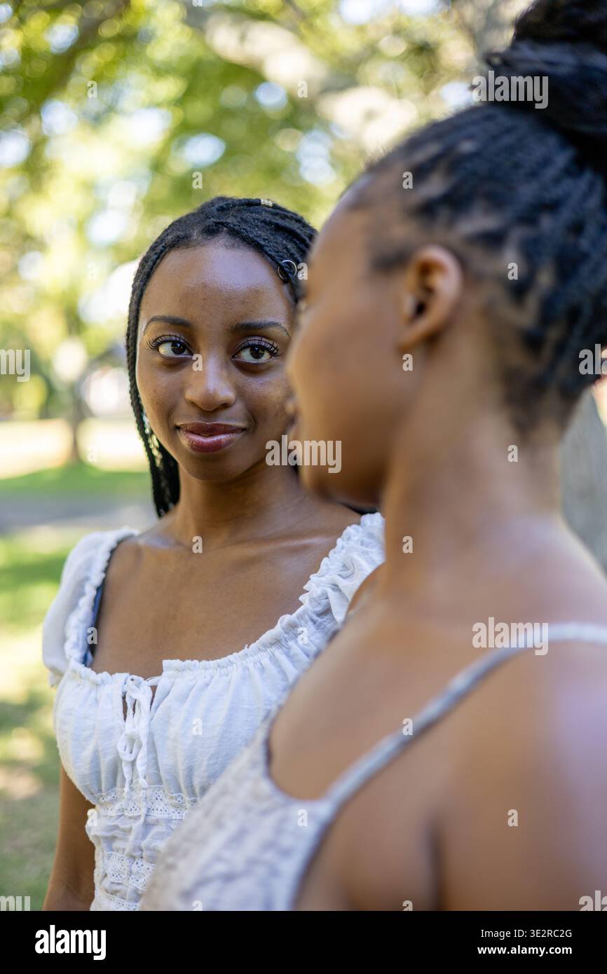 Black siblings interacting outside in a park Stock Photo