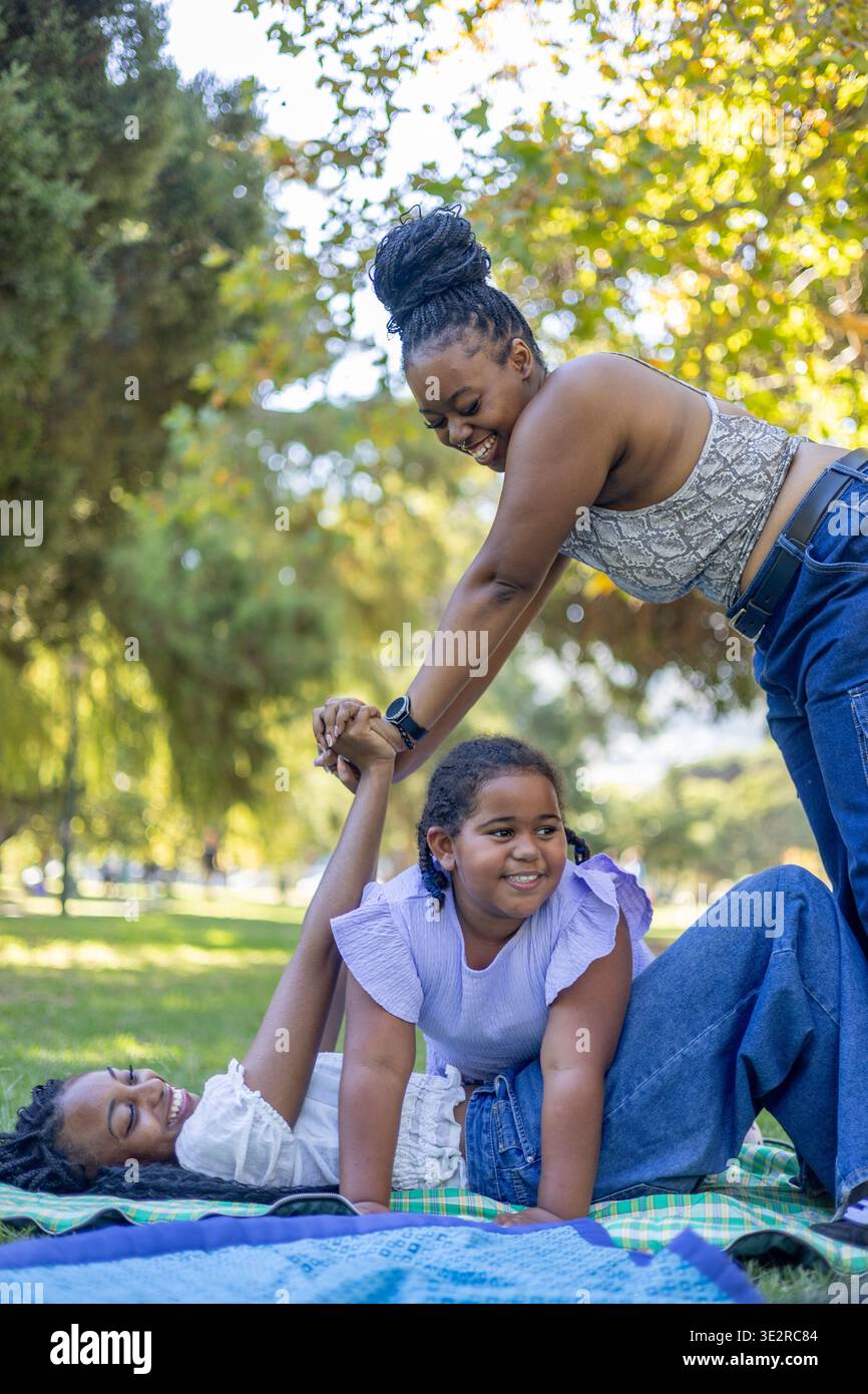 Black siblings interacting outside in a park Stock Photo