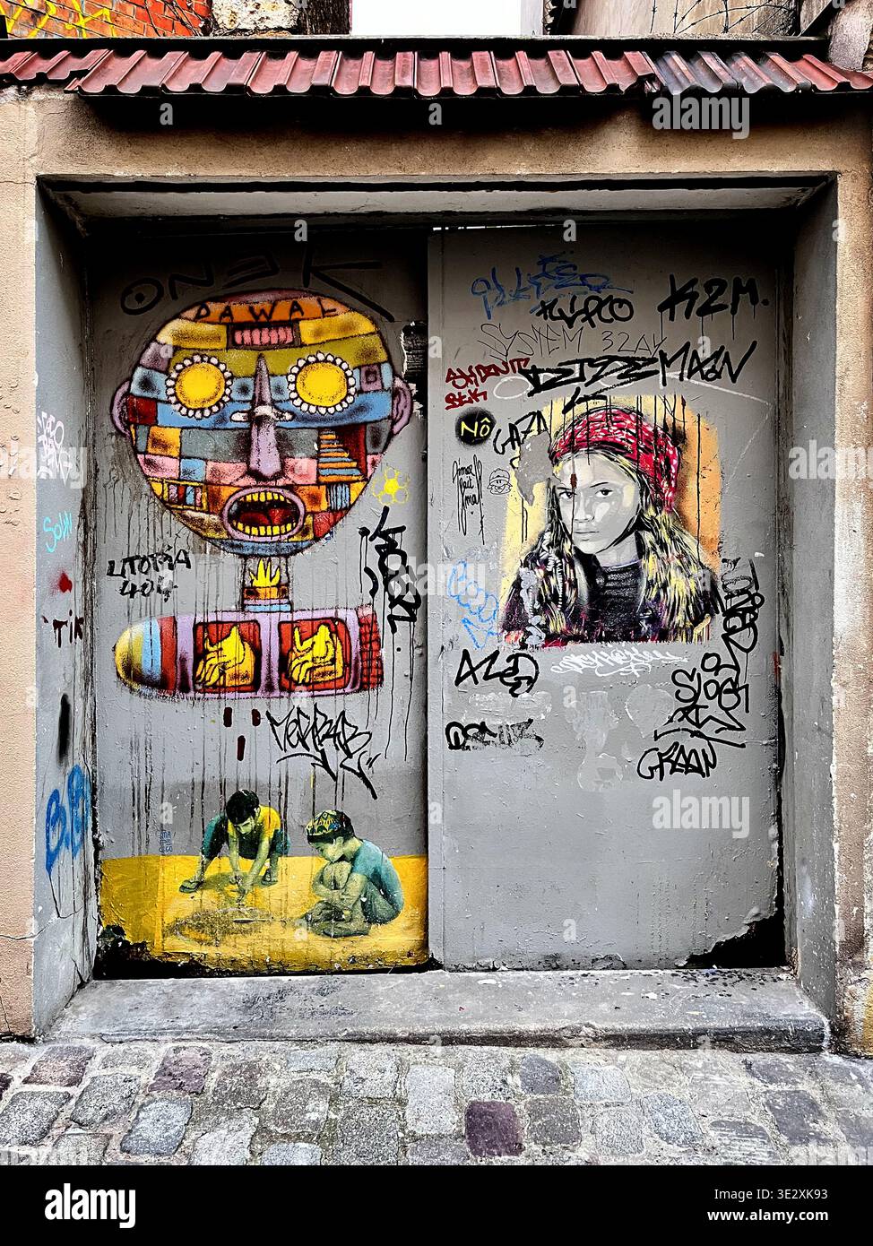 Street art and graffitis on an entrance door in Montmartre - Paris - France - Smartphone Captured Stock Image