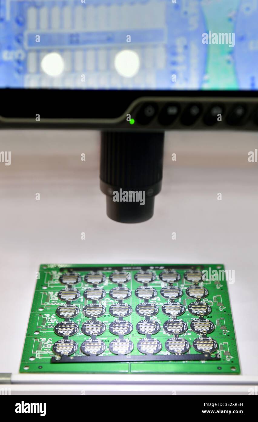 Digital microscope with LCD screen inspecting electronic circuit board ...