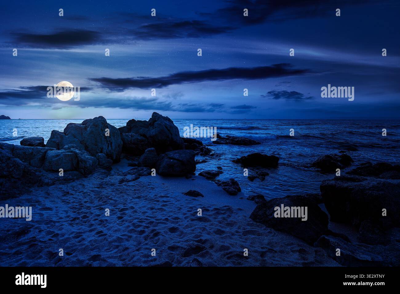 sandy beach landscape at night. full moon over coastal seascape scenery. mysterious nature background for summer vacation at the shore of black sea wi Stock Photo