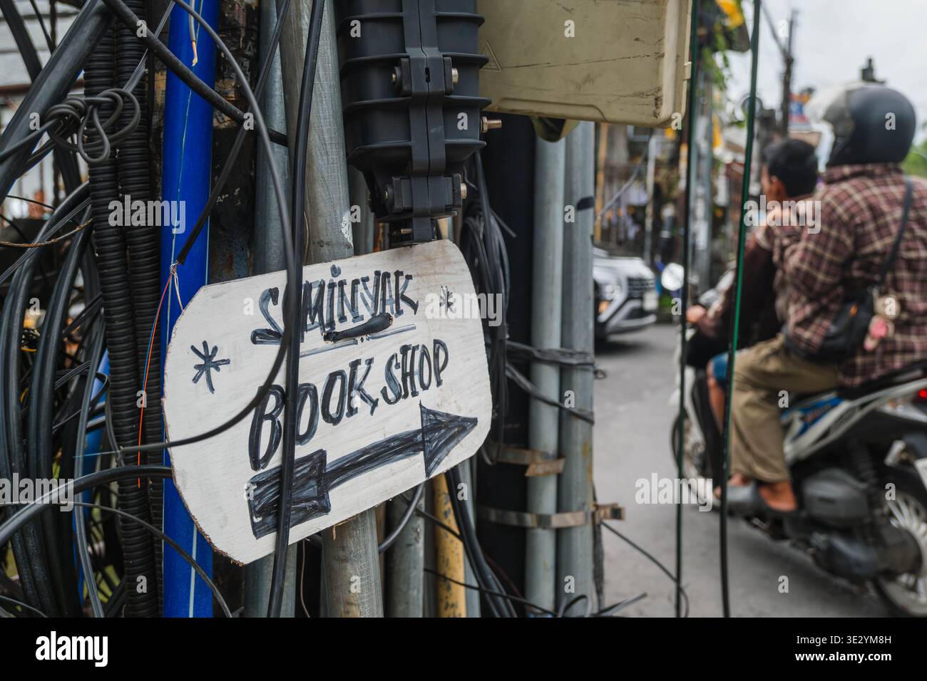 Seminyak Book Shop Directional Sign on a Utility Pole Stock Photo