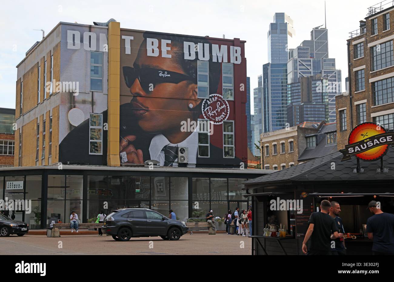 Large 'Don't Be Dumb' advertising mural in the Old Truman Brewery yard off Brick Lane, east London. Stock Photo