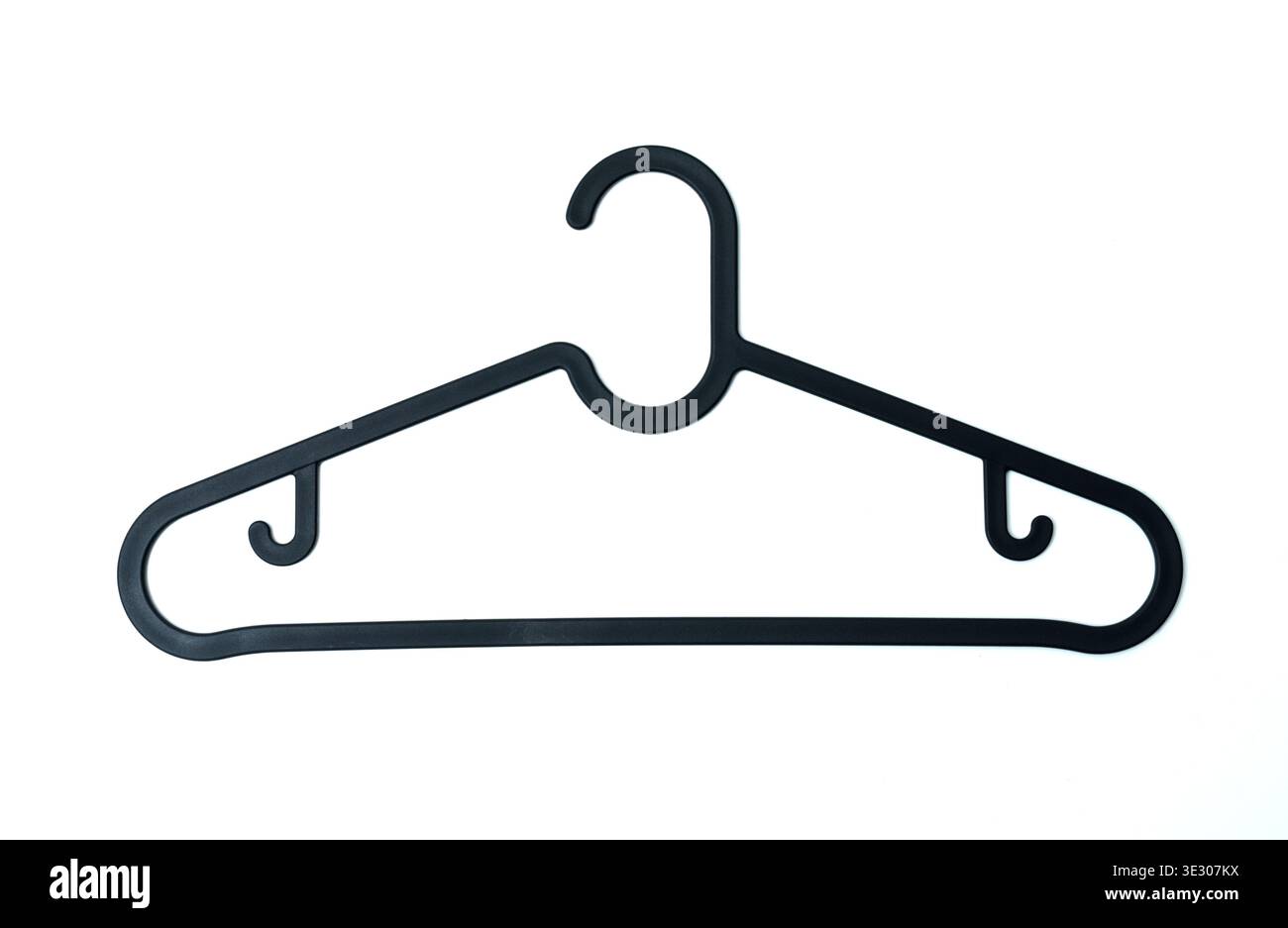 A black plastic clothes hanger with a smooth triangular frame and additional side hooks, isolated on a white background, showcasing a practical househ Stock Photo