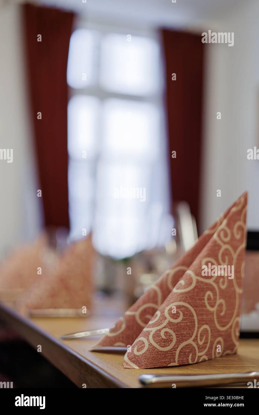 Folded Decorative Napkin on Restaurant Table Setting Stock Photo