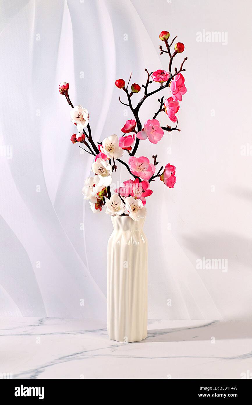 Elegant sunny colorful banner with pink blooming sakura branches in vase, abstract spring flower arrangement and template for your creative work, disp Stock Photo