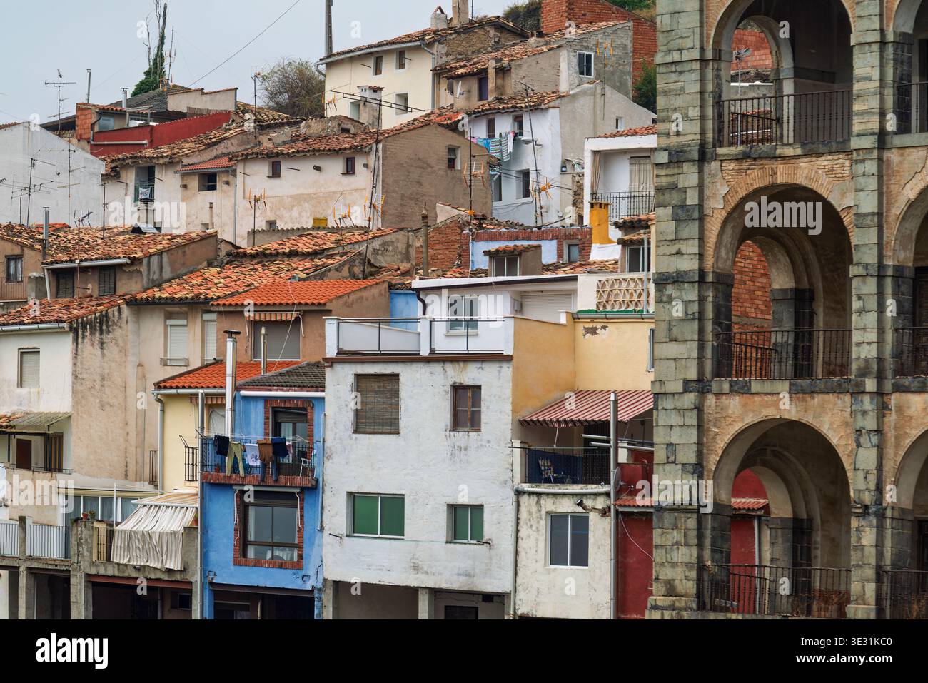 Traditional multi-colored houses and the arched stone facade of Palacio del Marques de Casa Torre in Igea, La Rioja, Spain. Stock Photo