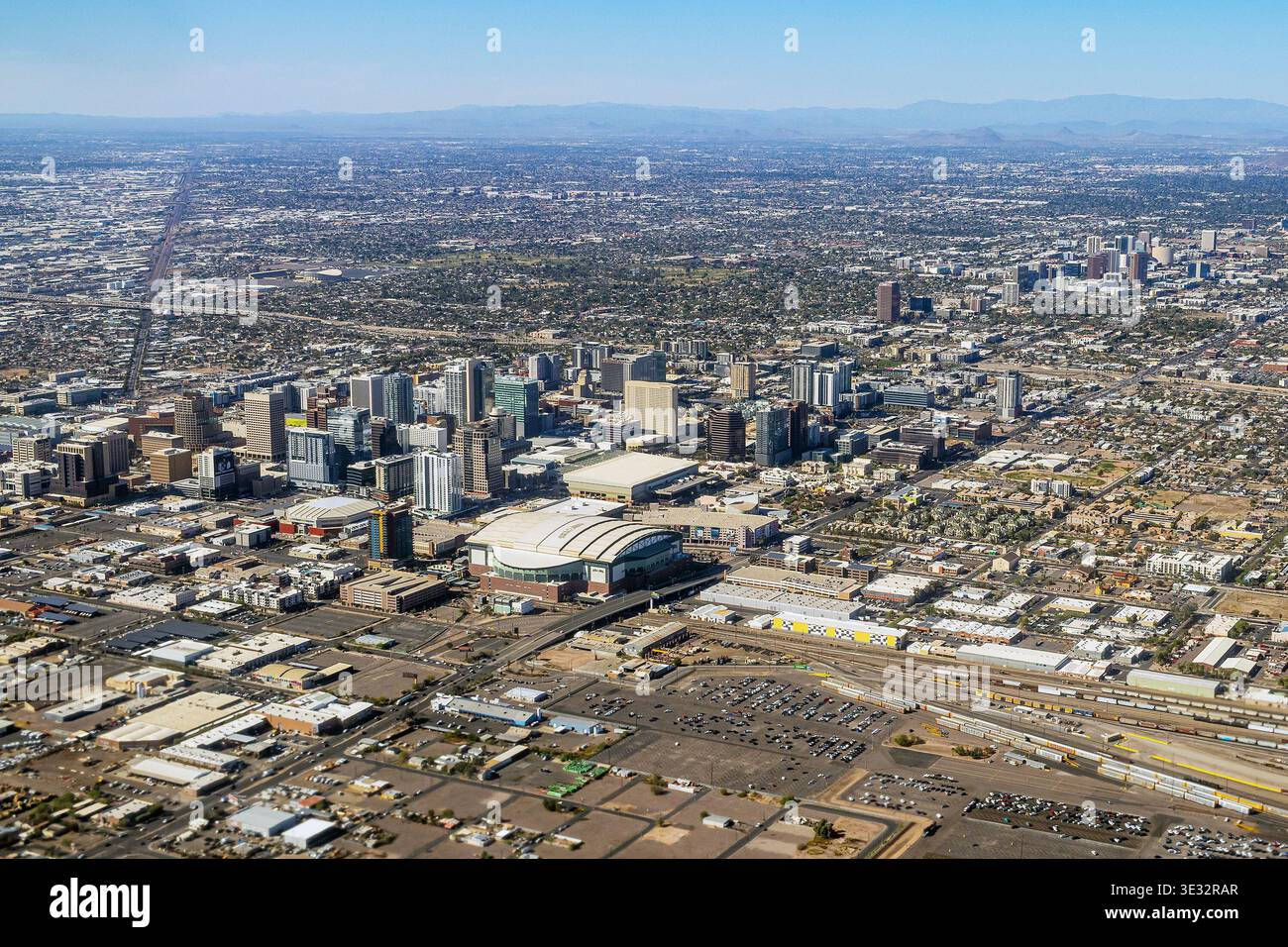 Aerial panoramic view of downtown Phoenix, Arizona, with central business district, surrounding neighborhoods, desert landscape under clear blue sky Stock Photo