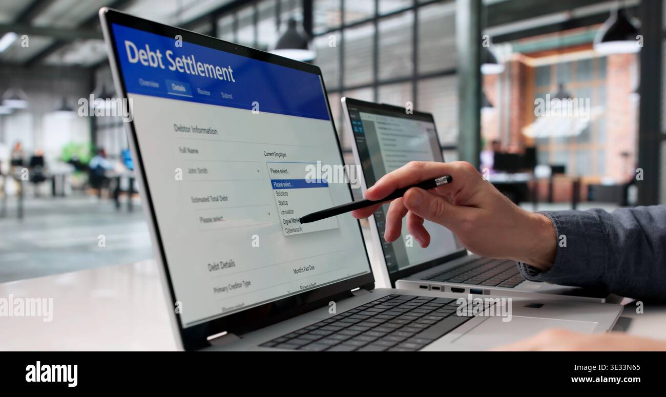 Financial Consultant Analyzing Digital Debt Relief Documents Across Several Monitors Stock Photo