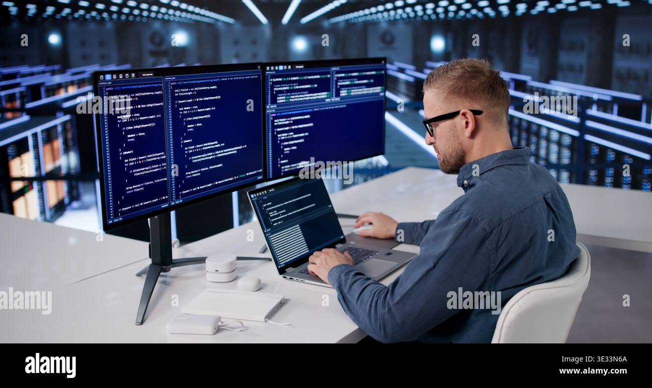 IT Professional Managing Cloud Data Protection In A High-Tech Server Facility Stock Photo