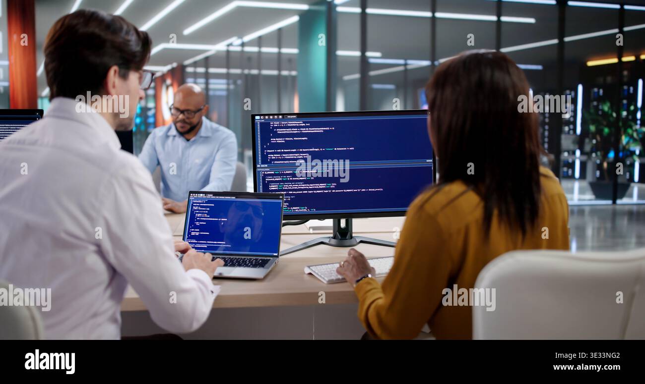 Diverse Team Of Software Developers Coding And Meeting In Modern Office. Programmers And Engineers Collaborating Stock Photo