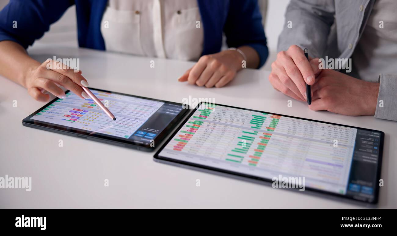 Healthcare Coder Analyzing Billing Data On A Tablet Device Stock Photo