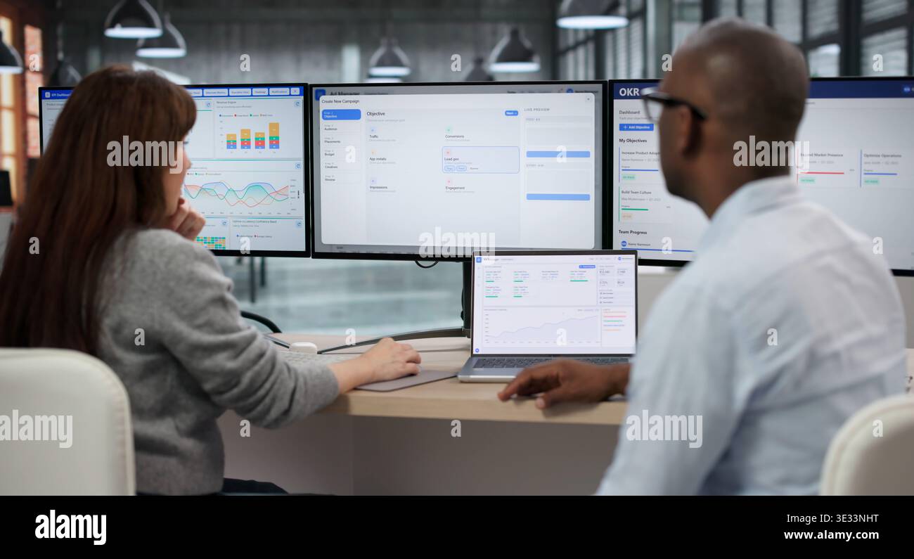 Two Managers Collaborate Online, Analyzing Real-time Data On Programmatic Ad Platform Stock Photo