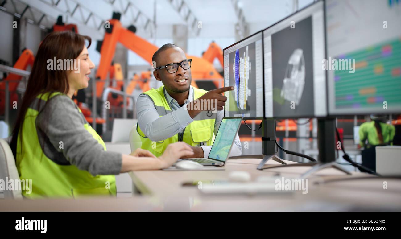 Young African Designer Uses Computer Software To Develop 3D Car Parts. Two Engineers Draft Stock Photo