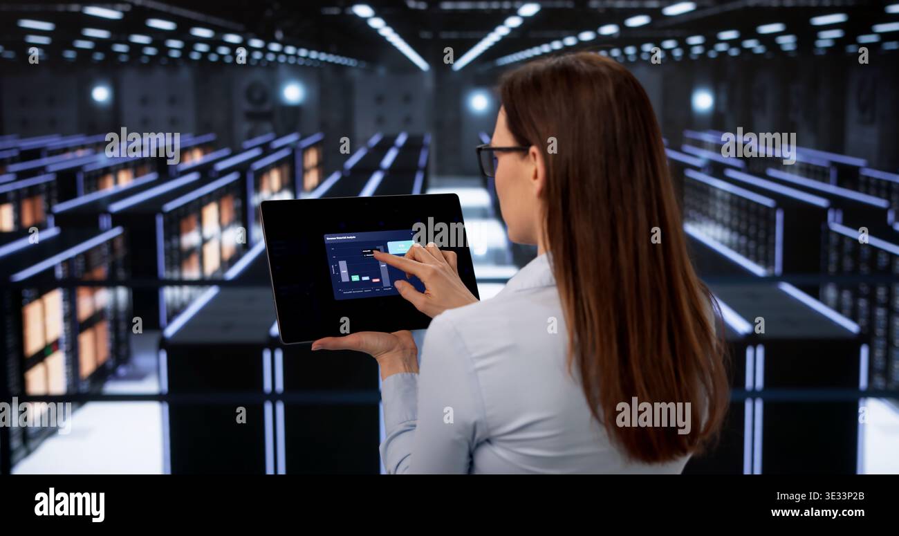 Female Data Technician Performs Thorough Security Checks In Cloud Server Room Stock Photo
