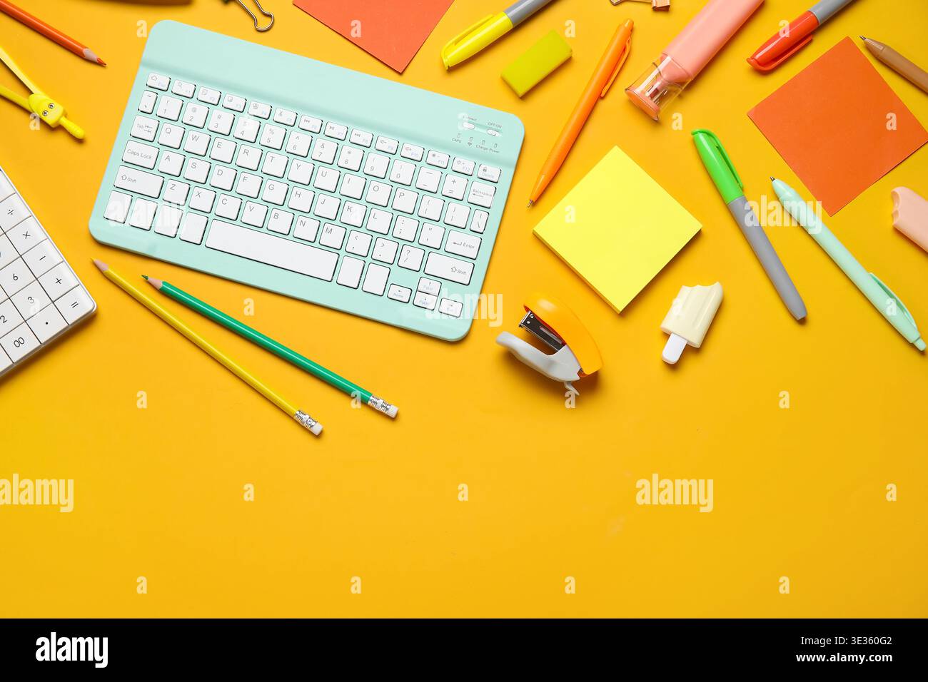 Composition with modern computer keyboard and different stationery on orange background Stock Photo