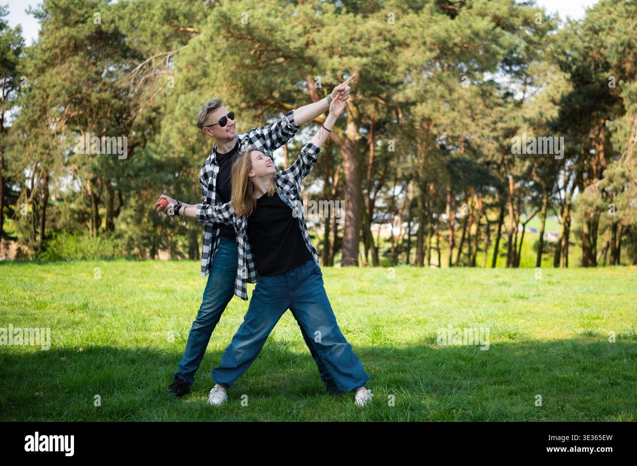 Happy Father And Daughter In A Family Look Outdoors Having Fun And Standing In A Star Pose Stock Photo