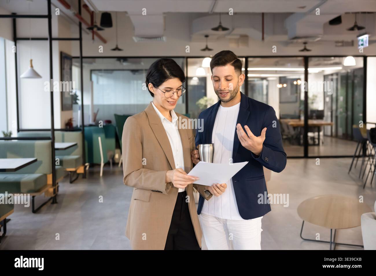 Two business colleagues reviewing printed document in office Stock Photo