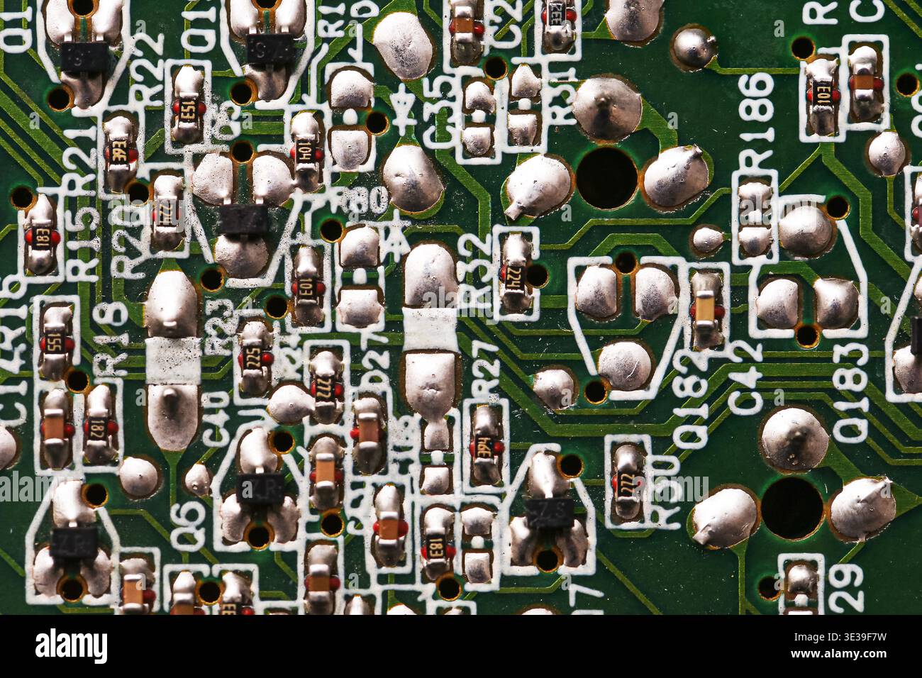 Electronic circuit board closeup with soldered components. Computer hardware and digital technology background with microelectronics detail. Stock Photo