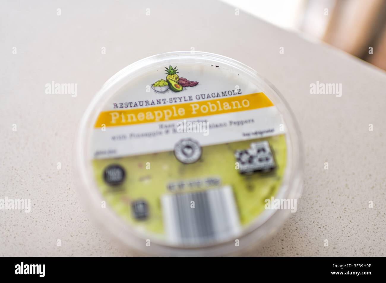 Roseland, USA - February 22, 2025: Plastic cup of avocado pineapple poblano guacamole variety by Park street deli Aldi brand restaurant-style Stock Photo