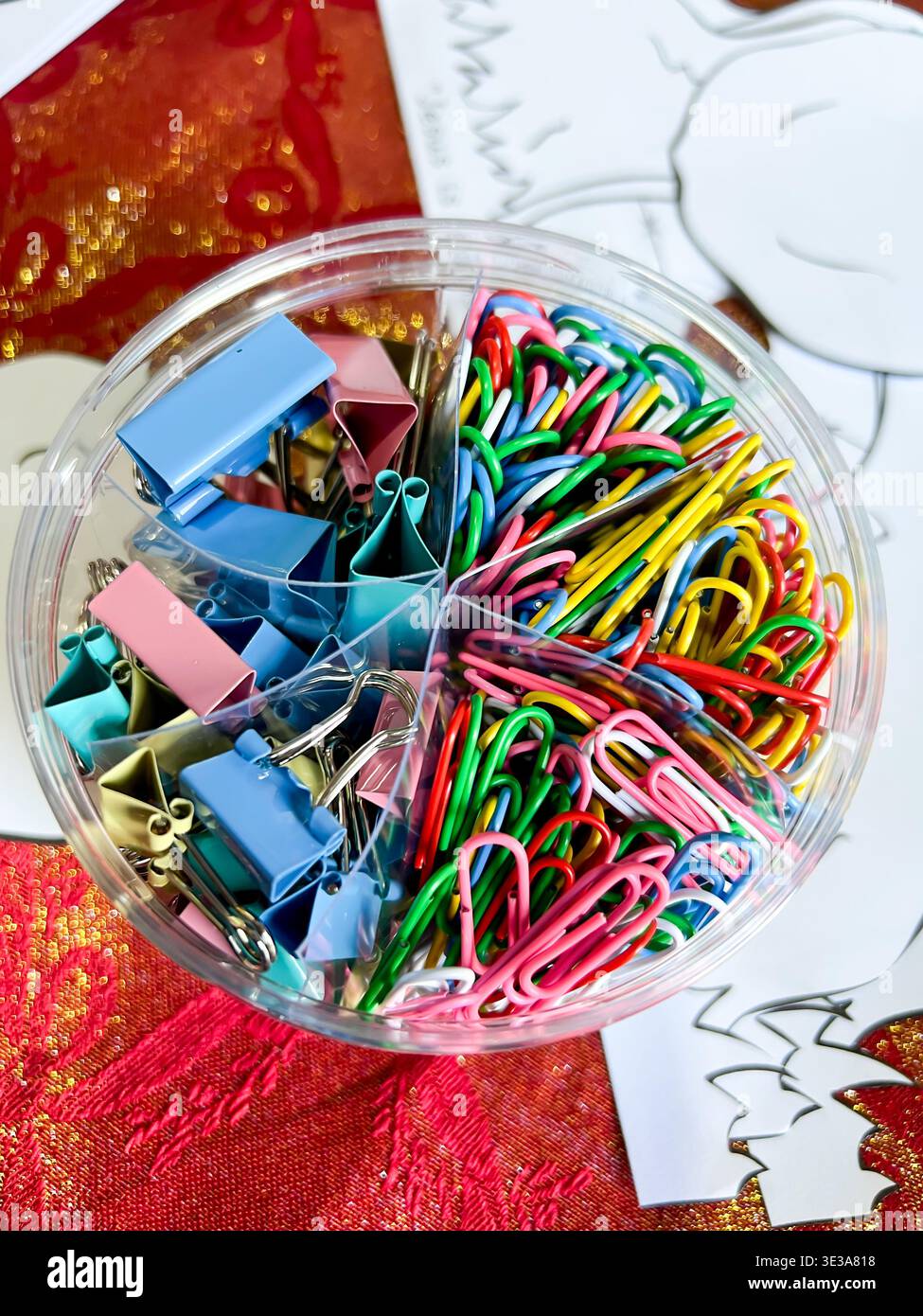 A storage container containing brightly coloured paper clips - Smartphone Captured Stock Image