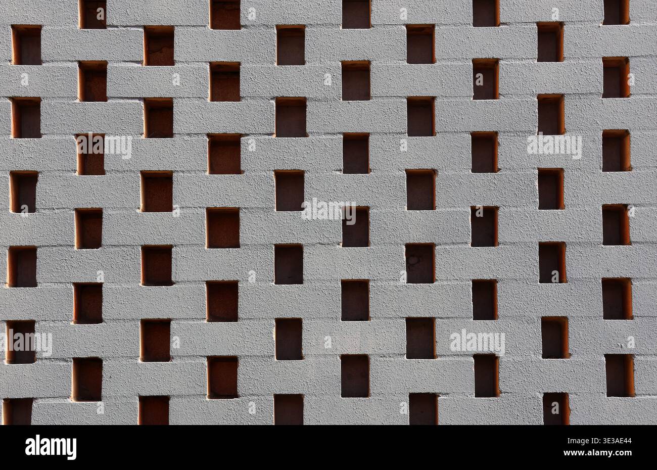 Brick wall with rectangular openings abstract textured background Stock Photo