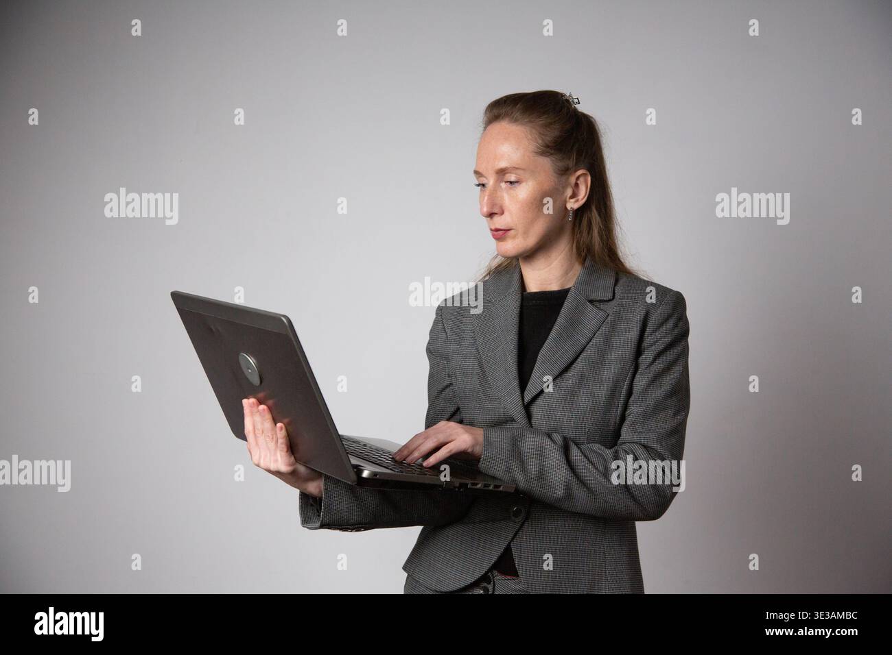 Woman in suit laptop office hi-res stock photography and images - Alamy