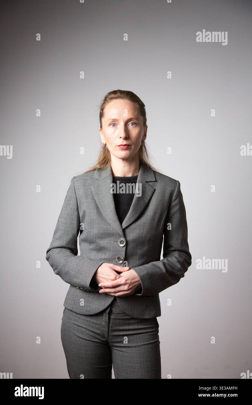 Vertical photo. A woman in a business suit with her arms folded. Stock Photo
